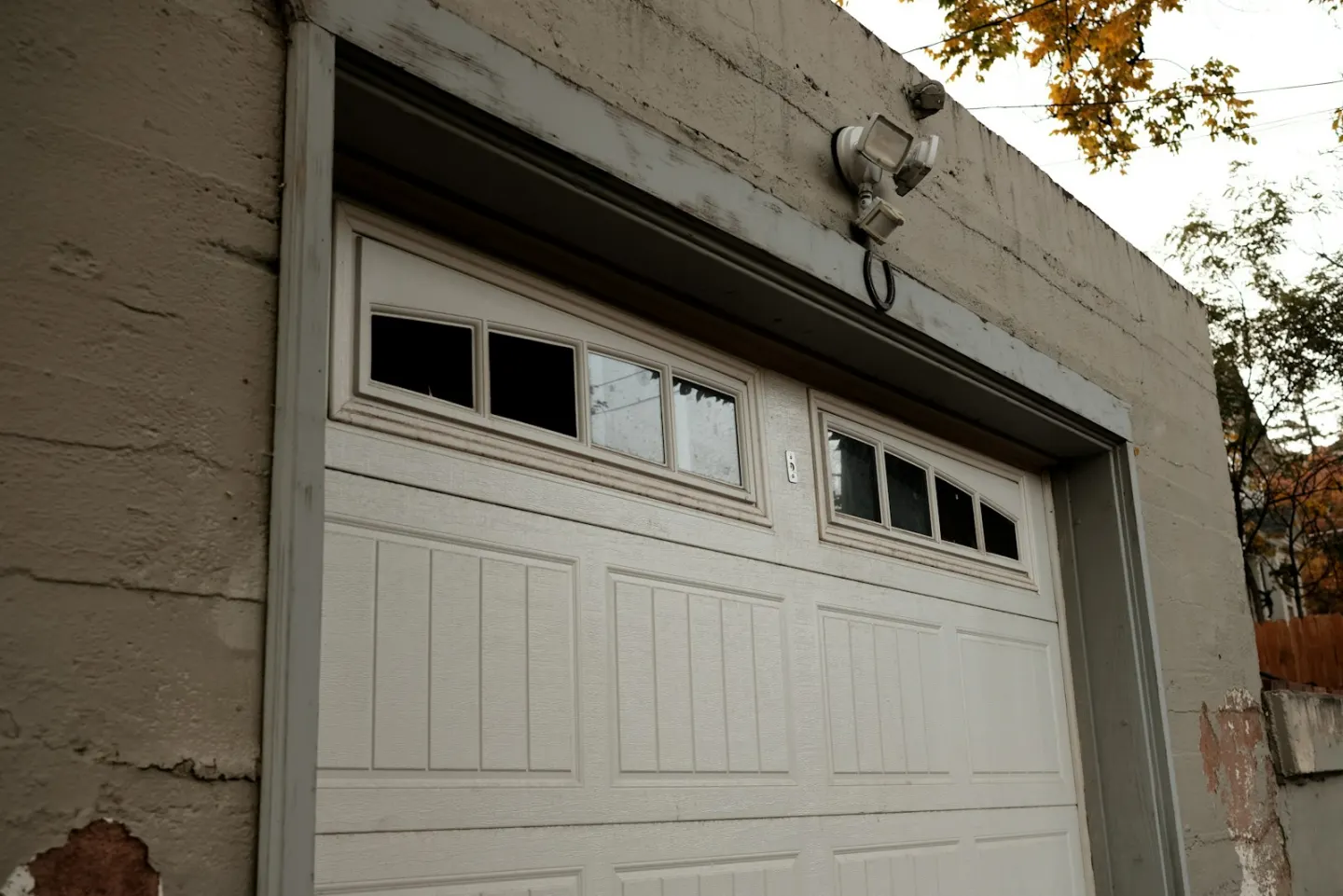 Closed white sectional garage door used as a contextual spring-repair image