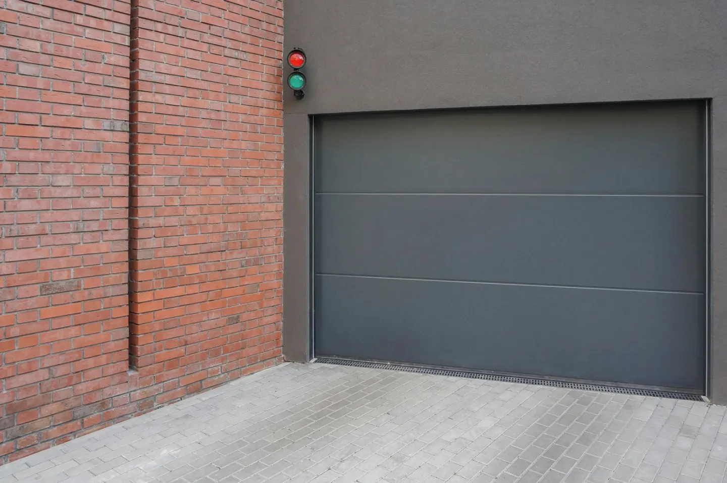 Grey sectional garage door used as a contextual track-repair image